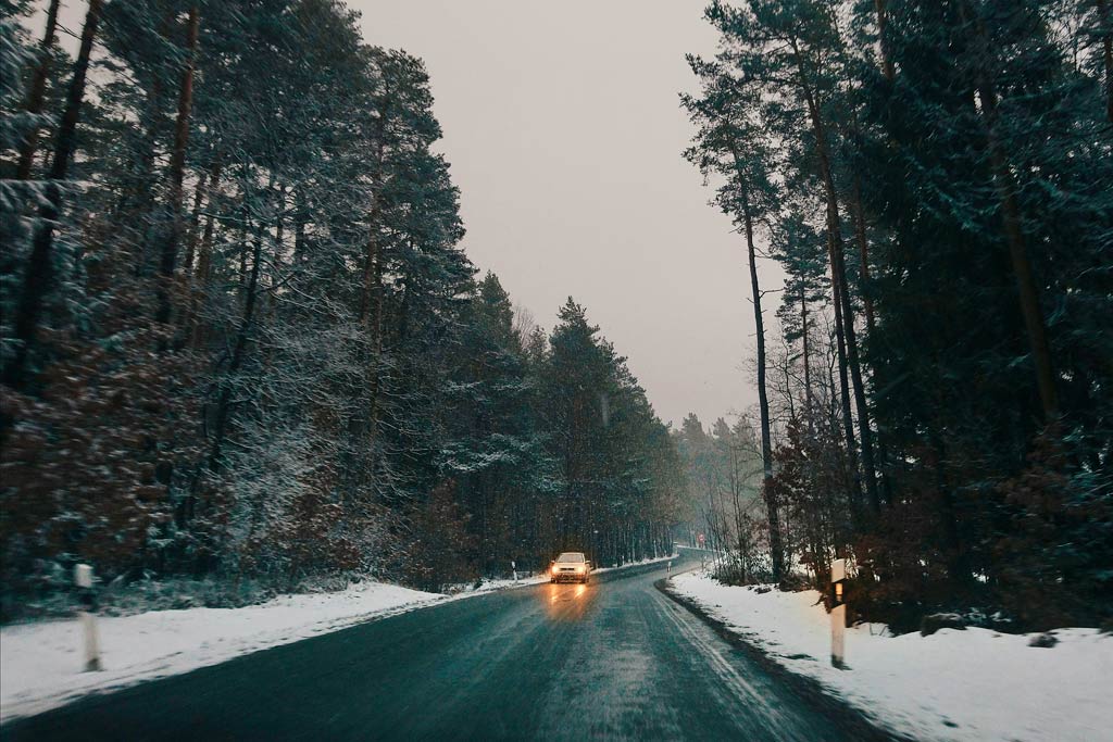 vista desde el conductor en carretera nevada con coche que viene de frente